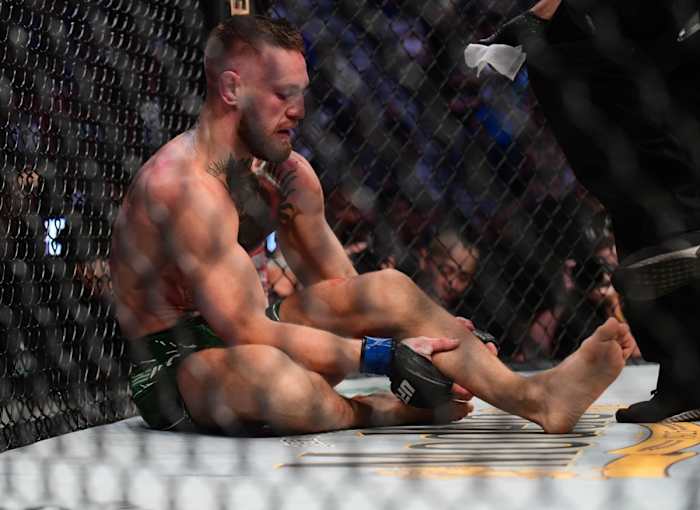 Conor McGregor holds his broken leg at UFC 264.